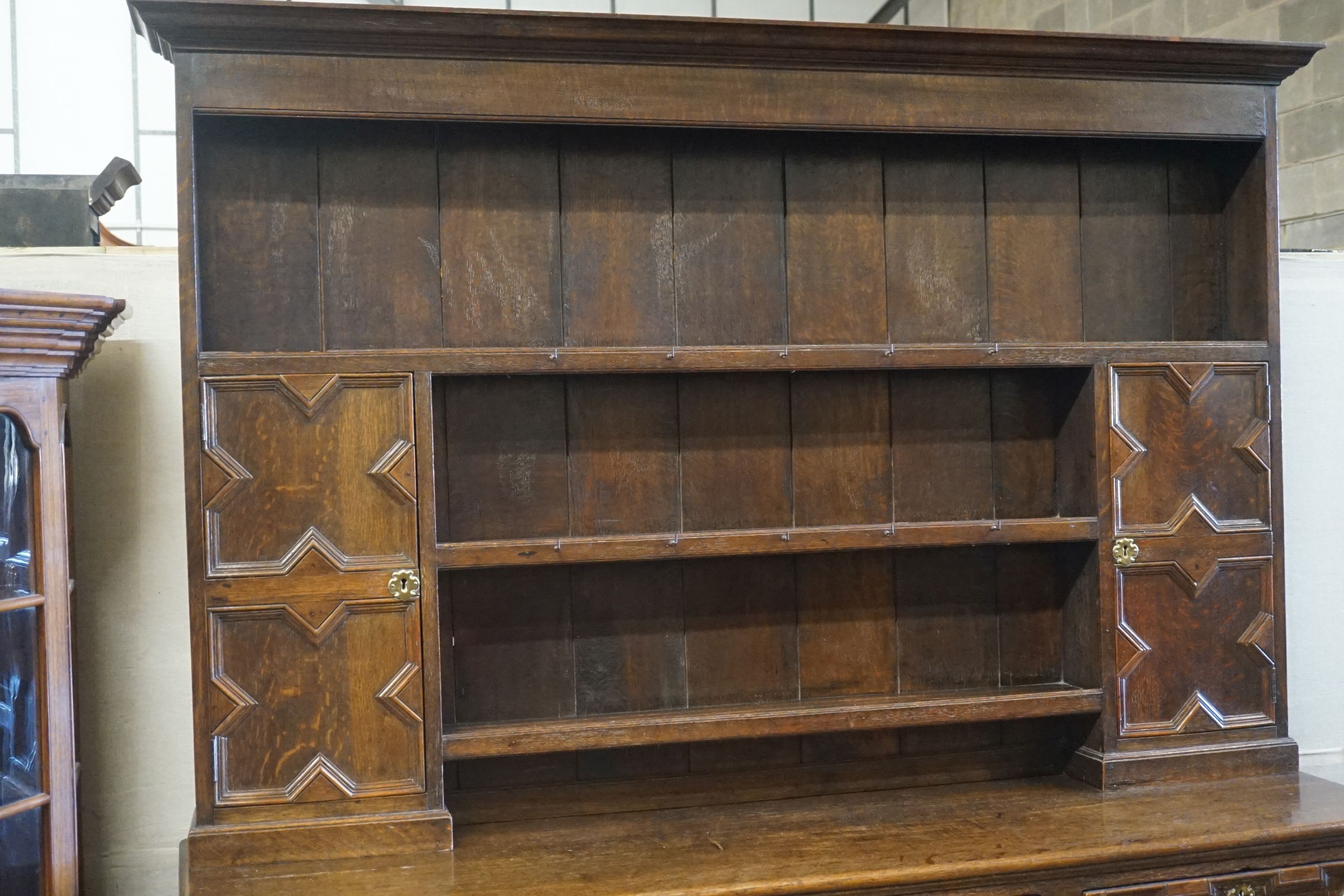 An 18th century oak dresser, length 180cm, depth 50cm, height 212cm